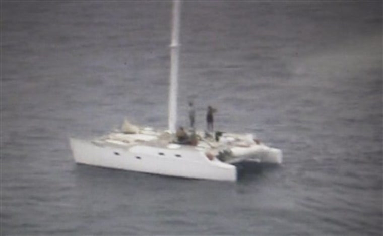 This still image from video released by the Philippine coast guard, shows American occupants on board the 38-foot catamaran "The Pineapple" as they wait to be rescued off the southern island of Dinagat, Philippines, on Sunday Jan. 23.